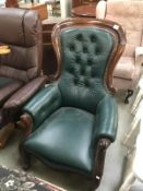 A mahogany framed green leather chair