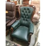 A mahogany framed green leather chair