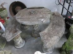 A stone circular table and two curved benches table top A/F