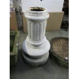 A cast iron planter in the style of a column,