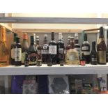 A shelf of alcohol, including wine etc.