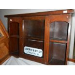 A Liberty & Co., of London display wall cabinet with sign to front and reverse label.