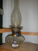 A Victorian glass oil lamp font with burner and chimney,