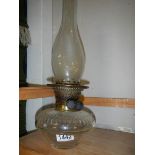 A Victorian glass oil lamp font with burner and chimney,
