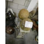 2 stone globes on plinths