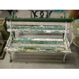 A cast iron and wooden garden bench