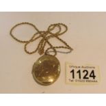 A 9ct gold locket (approximately 14 grams) on a yellow metal chain.