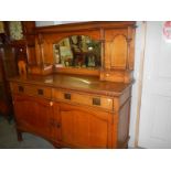 An oak mirror backed sideboard.