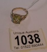 A 9ct gold ring set with citrine stone with fancy cross over shoulders, size V.