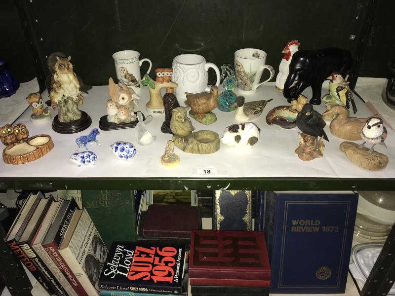A shelf of bird and animal figures,