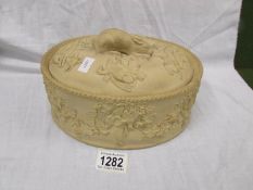 A late 19th century Wedgwood salt glaze game pie dish with oval lid and hare knop.
