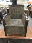 A dark wood stained wing armchair with cane panels
