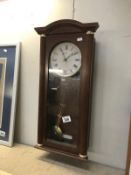 A Quartz wall clock with pendulum