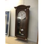 A Quartz wall clock with pendulum