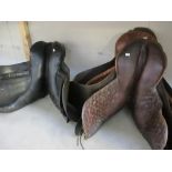 3 old saddles