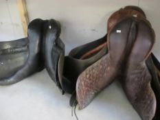 3 old saddles