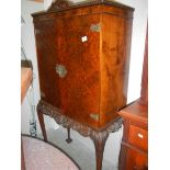 A walnut drinks cabinet.