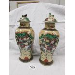 A pair of oriental lidded vases.