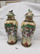 A pair of oriental lidded vases.