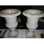2 cast iron urns