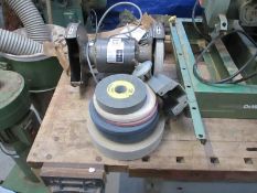 A bench grinder and wheels with maxi clamp