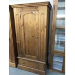A solid pine wardrobe with drawer