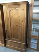 A solid pine wardrobe with drawer