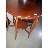 An Edwardian mahogany tea table with shaped edge