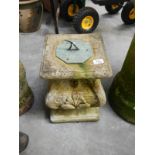 A sundial on a stone base
