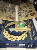 An album of Eastern bloc pin badges along with a tray of assorted pin badges and Esso and Shell