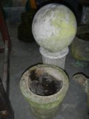 A stone ball on a column base and one other