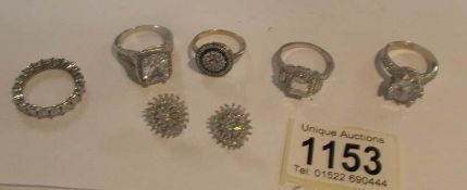 5 silver rings and a pair of earrings set with cubic zirconia's.