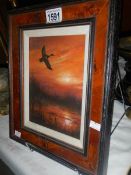 A John Trickett (B.1953) oil on canvas of mallard duck in flight at sunset, signed.