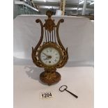 A Lyre shaped clock with key.