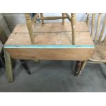 A Victorian pine kitchen table with drop leaves and turned legs