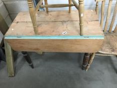 A Victorian pine kitchen table with drop leaves and turned legs