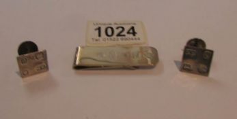 A pair of silver cuff links and a silver money clip, approximately 25 grams.