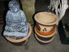5 decorative plant pots and a Buddha