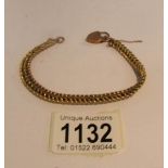 A gold bracelet with padlock clasp.