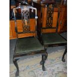 A pair of lacquered chairs.