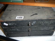 A 3 drawers shop display chest 'Carp's Torch'.