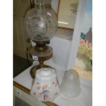 An oil lamp with glass font and original acid etched shade together with 2 1930's glass lamp shades.