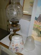 An oil lamp with glass font and original acid etched shade together with 2 1930's glass lamp shades.