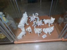 8 bisque porcelain dog figures.