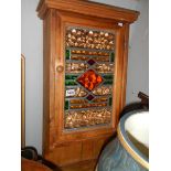 A pine wall hanging cabinet with lead glazed door.