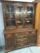 A mahogany astragal glazed bookcase with drawer/cupboard base