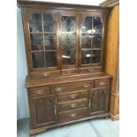 A mahogany astragal glazed bookcase with drawer/cupboard base