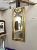 A gilt framed hall mirror