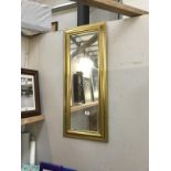 A gilt framed hall mirror