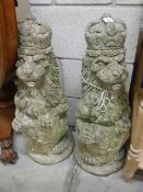 A pair of stone regal lions garden ornaments